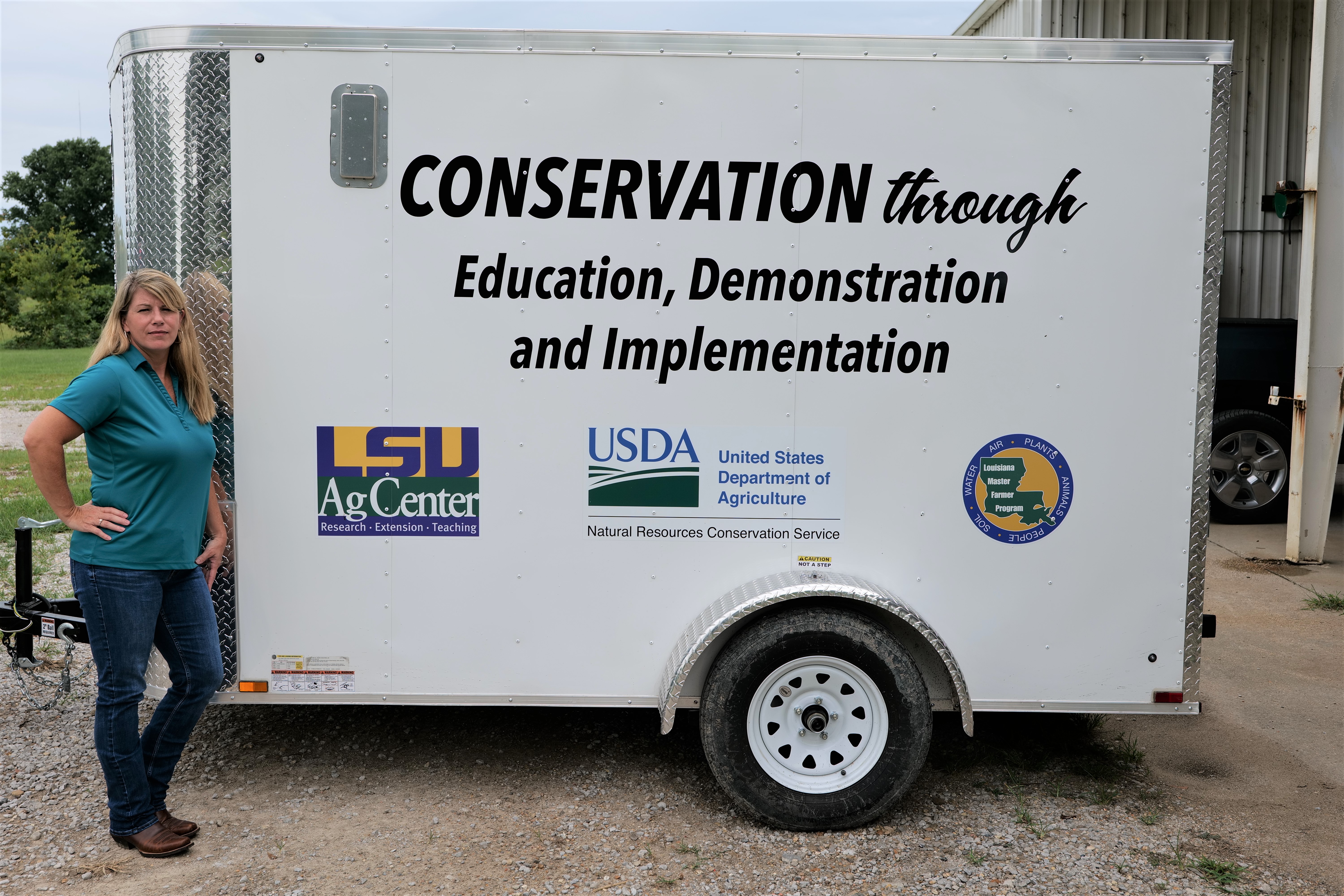 Donna Gentry standing next to a trailer.